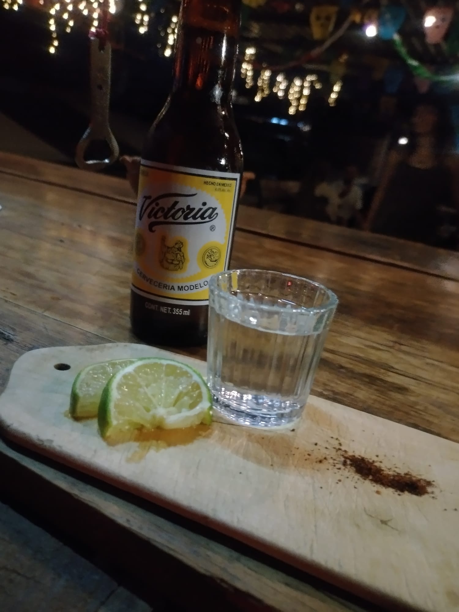 How to Make Money While Being a Nomad (No Digital Work) 🌍💸 Beer & Mezcal with some cut lemon and spice on the wooden board