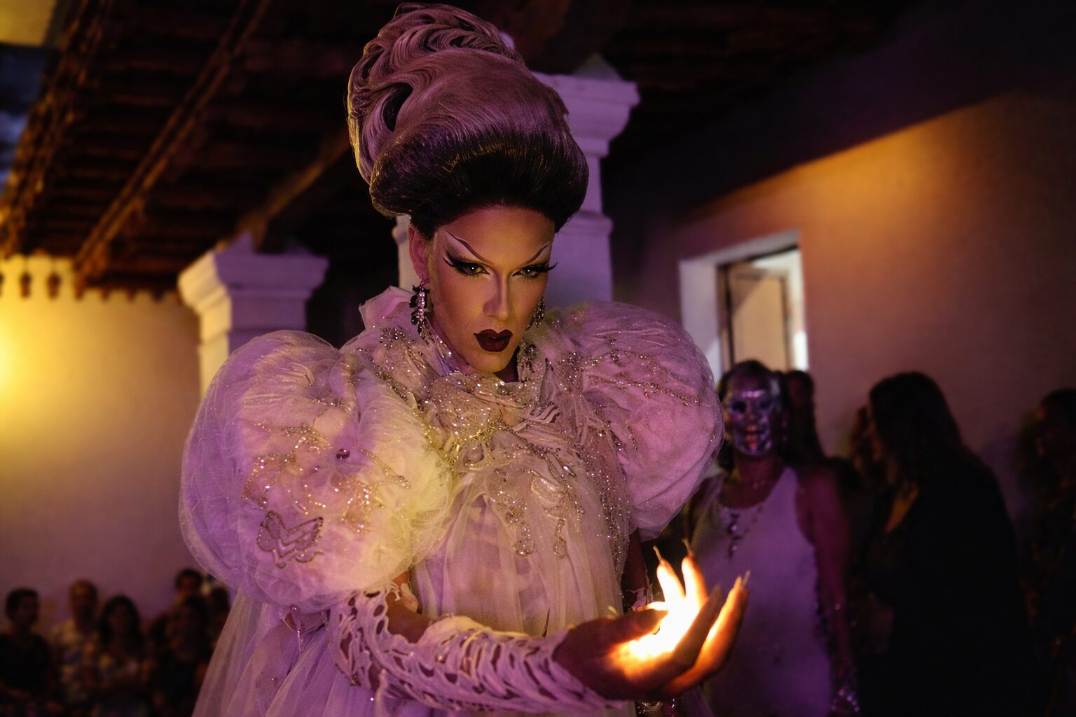 Drag queen artist mid-performance at a queer-friendly event in Oaxaca, Mexico, showcasing LGBTQ+ culture during Día de Muertos.