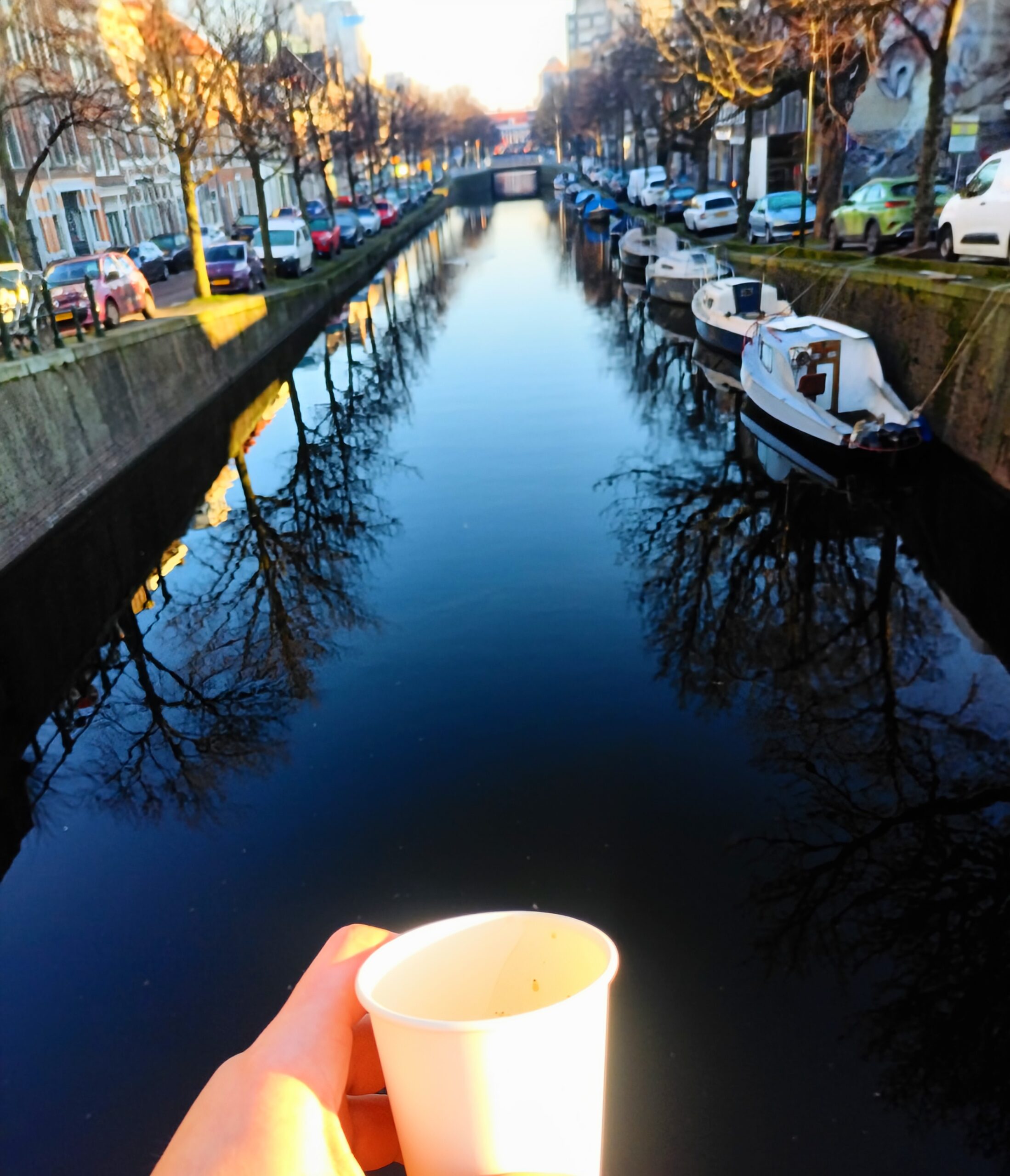 Canal view in Den Haag with historic buildings reflections on the water and boats